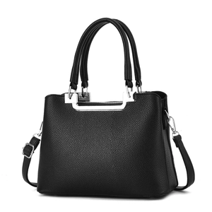 Close-up of black lychee grain texture and silver hardware on women's handbag