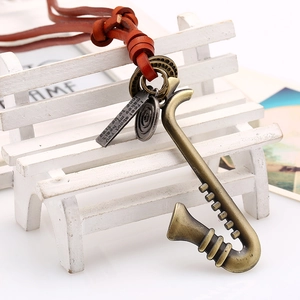 Vintage leather cord necklace featuring a brass saxophone pendant and engraved metal tags