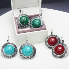 Detail view of retro bohemian earrings in three colors with Greek key silver edge
