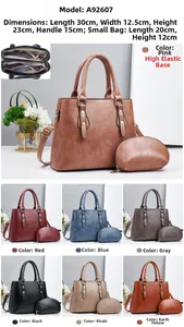 Detail view of large faux leather tote with interior zipper pockets and matching small pouch