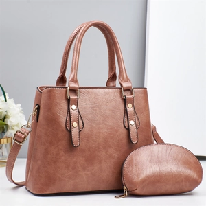 Brown faux leather handbag with matching coin purse and adjustable shoulder strap set