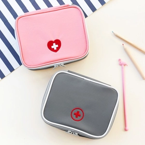 Close-up of portable mini medical pouch set with dual zippers and heart embroidery detail