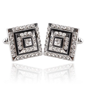 Detail of silver square cufflinks with black enamel and sparkling crystal inlay