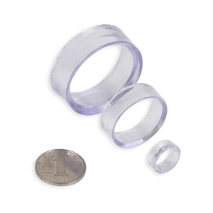 Three sizes of transparent acrylic bead display stands with coin for scale reference