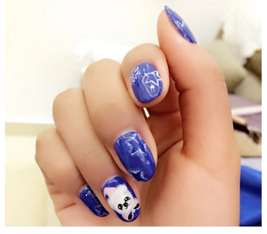 Close-up of handmade blue press-on nails featuring winter panda and snowflake designs