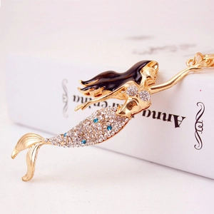 Sparkling rhinestone mermaid keychain in gold metal with blue accents and brown enamel