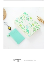 Detail of mint green leather card holder with litchi texture and smiley face lanyard