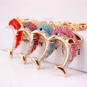 Sparkling dolphin keychains with colorful rhinestones in red, blue, pink, and purple