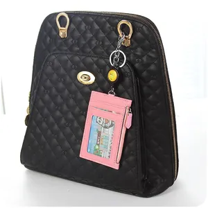 Pink leather card holder with retractable lanyard and clear window on black backpack
