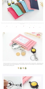 Detail of multi-slot faux leather card holder with zipper pocket and retractable keychain