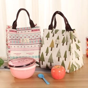 Detail of insulated lunch bags with bohemian patterns and trees on a wooden table