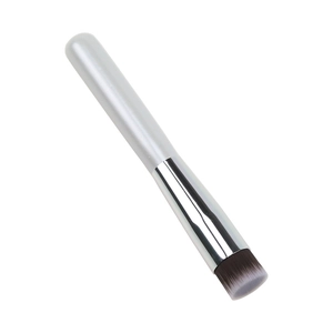 Detailed macro view of dual-tone synthetic bristles and silver ferrule of flat foundation brush