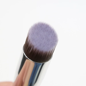 Macro shot of dense purple gradient bristles and polished silver metal ferrule on the brush