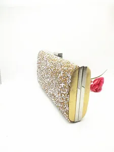 Detailed side view of luxury evening clutch bag with sparkling gold and silver sequins