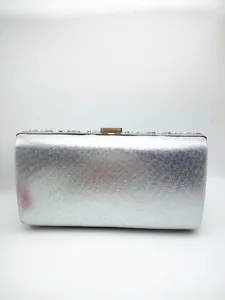 Detailed view of silver glitter evening clutch bag with elegant golden top metal clasp