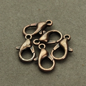 Detailed macro view of five vintage bronze zinc alloy lobster clasps for DIY jewelry