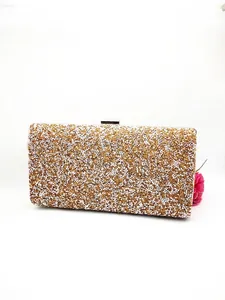Close-up of sparkling gold and silver glitter texture on luxury evening clutch bag
