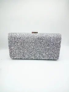 Detail of silver glitter evening clutch bag with metallic rectangular clasp and hard shell