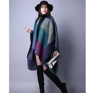 Detailed view of women's thick geometric color block knit poncho shawl with autumn style