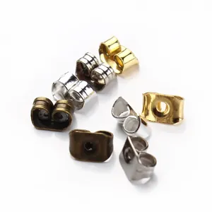 Macro view of butterfly earring backs in gold, silver, and bronze metal finishes