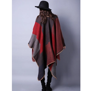 Detailed view of red and grey plaid knit fabric with high-quality edge stitching finish