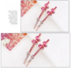 Macro shot of rose gold bow hair clips with crystal inlay and magenta rhinestones