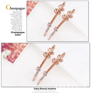 Detail of two-piece champagne crystal butterfly hair clips in elegant rose gold finish