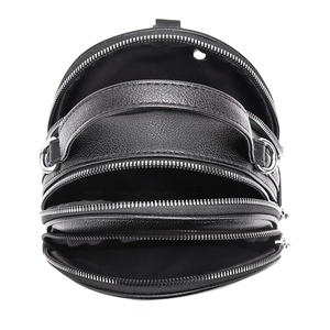 Macro view of black leather backpack showing three zipper layers and pebbled texture