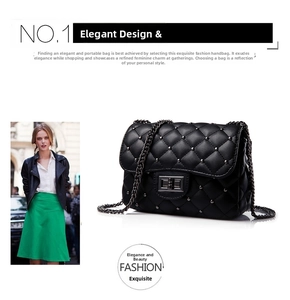Close-up of black quilted shoulder bag with metal studs and vintage chain strap