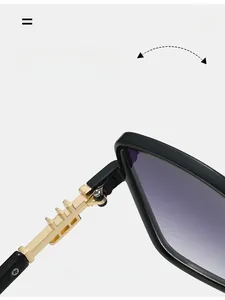 Close-up of durable golden metal hinge on black square frame sunglasses with gradient lenses
