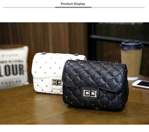 Detail of quilted leather mini bags with silver studs and metal twist locks
