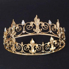 Detailed macro shot of golden crown with fleur-de-lis patterns and shiny rhinestones
