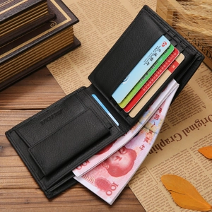 Short bifold men's black genuine leather wallet with multiple card slots on vintage desk