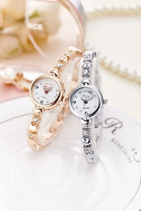 Close-up of rose gold and silver quartz watches with heart shaped rhinestone bracelet
