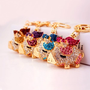 Set of creative flying pig keychains with glittering rhinestones in four colors