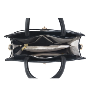Interior view of black leather handbag featuring three-layer compartment and zipper