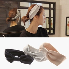 Detail view of stylish velvet fabric headbands with bow design in black, grey and beige