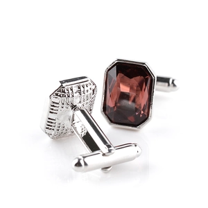 Detail of silver shirt cufflinks with dark brown rectangular gemstone and T-bar closure
