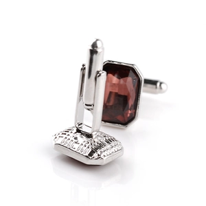 Polished silver cufflinks with rectangular red-brown faceted crystals and toggle clasp