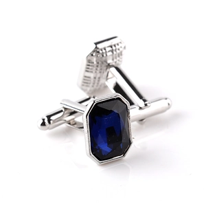 Macro shot of silver cufflinks with rectangle blue glass stone and bullet back closure