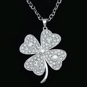 Detailed view of silver clover pendant with pave-set white sparkling crystals