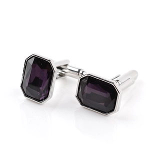Detail view of purple octagonal cut glass gemstones set in silver metal cufflinks