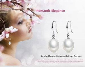 Detailed view of natural white freshwater pearl drop earrings with silver fish hook clasps