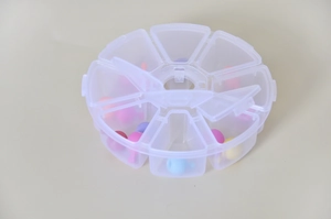 Macro shot of 7-day transparent round pill organizer with colorful medicine capsules