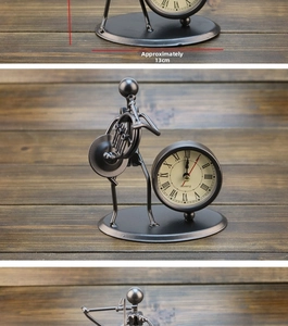 Detailed view of vintage iron desk clock shaped as a musician, measuring approx. 13cm
