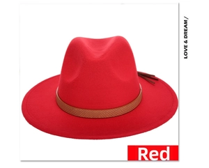 Detail view of red wool fedora hat featuring a brown snakeskin band and leather tassels