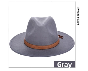 Detail of grey fedora wool hat with brown leather band and tassel fringe accessory