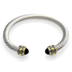 Twisted cable cuff bangle in stainless steel with gold accents and black gemstones