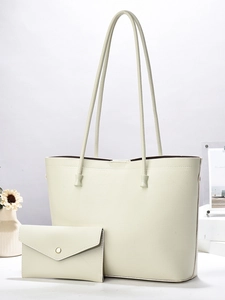 Close-up of beige tote bag set with vein pattern texture and matching envelope wallet