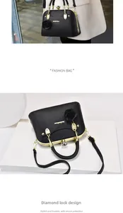 Detail of black pebbled leather handbag with diamond-shaped lock and 3D rose ornament